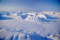 Aerial of frozen peaks and sea ice in winter Svalbard, Norway