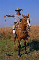 Gaucho prepares to burn grassland. Land management. Ibera NR, Argentina, South America