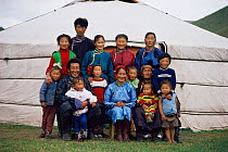 Mongolian family outside traditional ger / yurt, Hangay mountains, Mongolia.