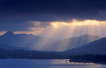 Dark clouds with shafts of sunlight hitting the water, Bantry Bay, Republic of Ireland