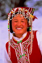 Nosi Yi ethnic woman portrait in summer dress, Mtns north of Lijiang, Yunnan Province, China