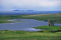 Landscape with stone tower, Uist, Outer hebrides, Scotland, UK