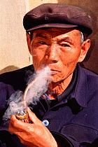 Han man smoking pipe Shilin, Yunnan, China. 2002