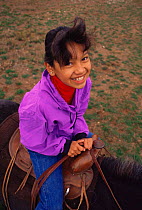 Native American child portrait on horseback, Taos Pueblo, Taos, New Mexico, USA