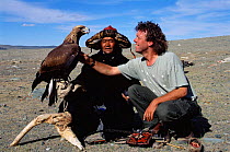 Photographer Pete Oxford with Golden eagle used for hunting by Kazakhs. Tsengel Khairkhan mtn, W Mongolia