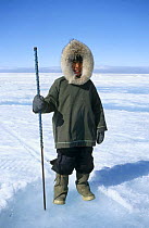 Inuit boy in traditional clothing on trip to floe edge Nunavut, Baffin Island, Canadian Arctic