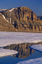 Cliffs and melting sea ice of Admiralty Inlet, Baffin Island, Canadian Arctic