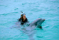 Charlotte Uhlenbroek swimming with Bottlenose dolphin during filming for BBC TV series Talking With Animals, Bahamas, 2002