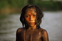 Portrait of Kayapo indian boy with body painted using plant dye, Amazon Basin, Brazil