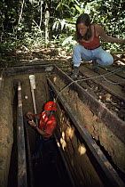 Rainforest research team studying underground gas emissions, Para State, Brazil