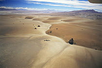 Aerial view of barren landscape and a solitary dirt road through the altiplano at 4500m, Bolivia, South America