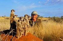 Film-maker Simon King with family of Meerkats {Suricata suricatta} Tswalu Kalahari Reserve, South Africa. 2002. aka Suricate