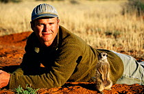 Film-maker Simon King with Meerkat {Suricata suricatta} South Africa 2002. Also called Suricate