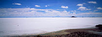 Car crossing Uyuni, largest salt pan in world, south west Bolivia, South America