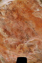 Hand stencils, Aborigine rock art, Nanguluwur site, Kakadu NP, Australia - paint sprayed from mouth around hand