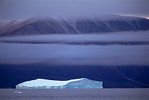 Iceberg with land behind, Qaanaaq, Greenland