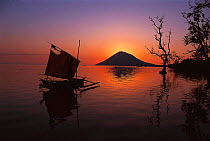 Silhouette of boat and Manado Tua island, Sulawesi, Indonesia
