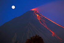 Siau volcano erupting with moon behind, N Sulawesi, Indonesia