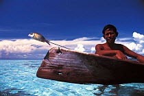 Bajau fisherman with catch, Malaysia. Nomadic tribe who live on the sea.