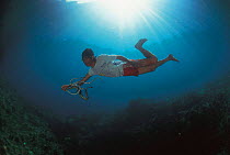 Seasnake fisherman catching seasnakes underwater, Gato island, Philippines.