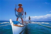Whale shark hunter on boat with fish hook, Pamilacan, Bohol, Philippines. 1997