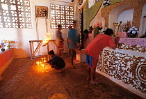 Sunrise offering to the gods in chapel by Whale shark hunters for safety, Pamilacan, Bohol, Philippines. 1997