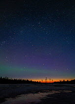 Aurora borealis colours in midnight sky, northern Finland, April