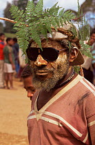 Huli man at market with fern headress, Tari, Central Highlands, Papua New Guinea