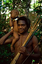 Hagehai hunter and child holding weapons, Papua New Guinea