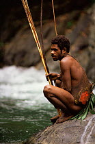 Hagehai warrior sitting by river, Papua New Guinea