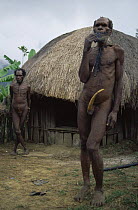 Elogun man and neighbour in front of Honai Sekan, Balieum Valley, Irian Jaya / West Papua, New Guinea, 1991 (West Papua).