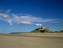 Bamburgh Castle on edge of beach, Northumberland, UK.