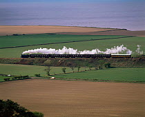 Preserved steam train travelling along coast, Norfolk, UK.