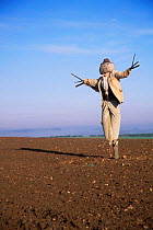 Scarecrow in ploughed field, Norfolk, UK, October 1998