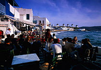 People eating outside in restaurants in 'Little Venice' Hora, Mykonos, The Cyclades, Greece Europe