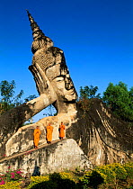 Buddhist and giant stone statue of Reclining Buddha at Xieng Khuan, Vientiane, Laos South East Asia