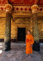 Buddhist monk by Gold Relief on Wat Mai Suwannaphumaham, Luang Prabang, Laos, South East Asia