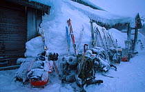 Skiis and rucksacks outside mountain hut after snow storm. Finse, Hardangervidda, Norway