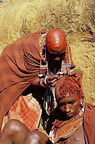 D - Maasai traditional ceremony, Kedong Valley, Rift valley, Kenya. Ritual shaving of son's hair in E-unoto ceremony. 1985