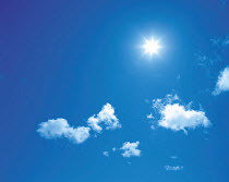 Y-2706 Sun shining above cumulus clouds in blue sky