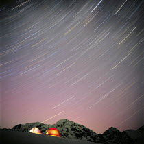 Y-12203 Timelapse of star paths above tents on mountain, Alaska USA