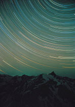 Y-12206 Timelapse of star paths above Northern Japanese Alps peaks, Japan