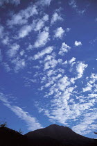 Y-6807 Altocumulus clouds above peak in blue sky