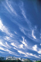 Y-6504 Cirrus clouds in blue sky above mountain range, North America