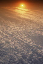 Y-7503 Sun setting below cirrrocumulus clouds in evening sky