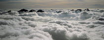 Y-9203 Aerial view of clouds around mountain peaks