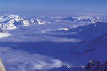Y-9105 Aerial view of cloud lieing in valley below mountain peaks, Chamonix from Aiguille Du Midi, France
