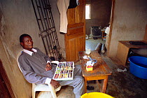 Man with catalogue of wild fish for export, Nigeria, West Africa 2002