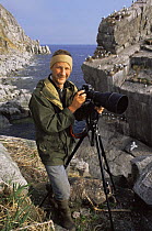 Photographer and field assistant Ben Osborne photographing seabirds in Talan, Sea of Okutsk, Eastern Russia. On location for Blue Planet, 2002