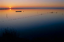 Fishing boat and nets at sunset, Camargue, France